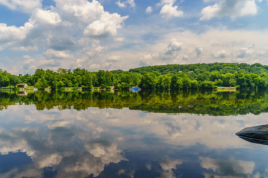 Langhorne PA - View of Blue River with Cloud Reflections and Forest in Langhorne Pennsylvania