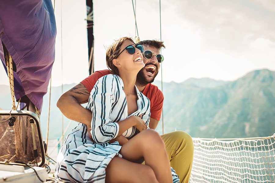 Personal Insurance - Young Couple Having Fun on a Luxury Yacht at Sea