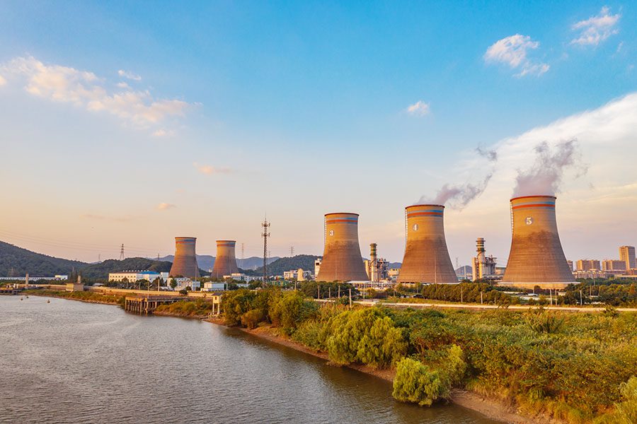 Public Utility Insurance - View of Modern Power Plant Against Blue Sky