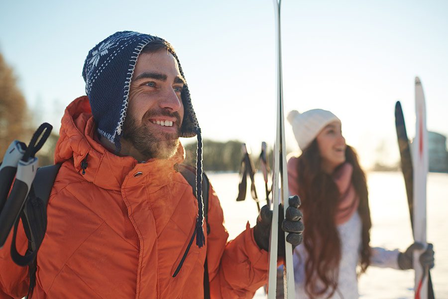 Testimonials - Group of Smiling Skiers Looking Out at the Distance