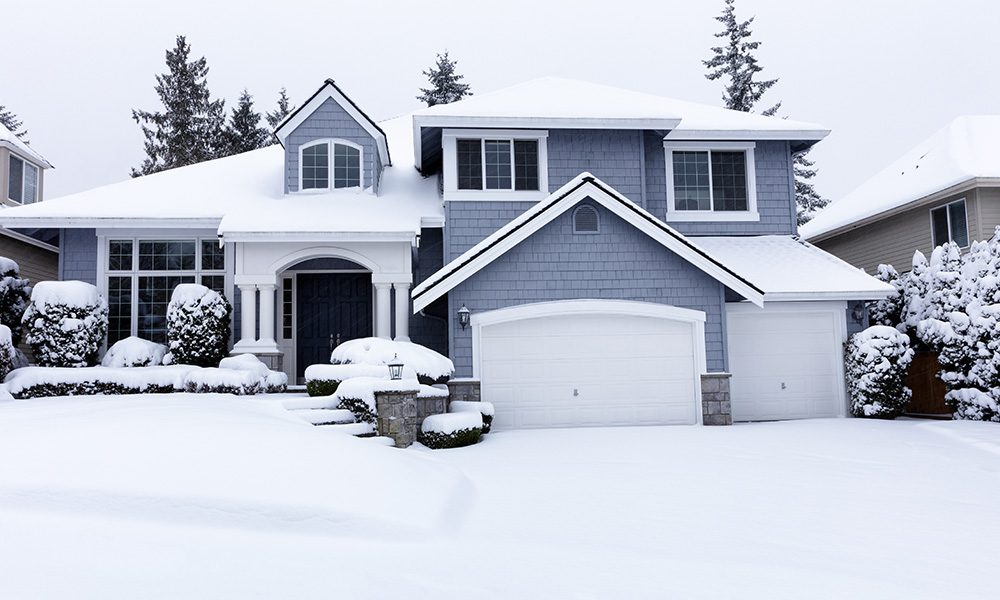Blog - Two Story House with Attached Garage Covered in Snow in the Winter